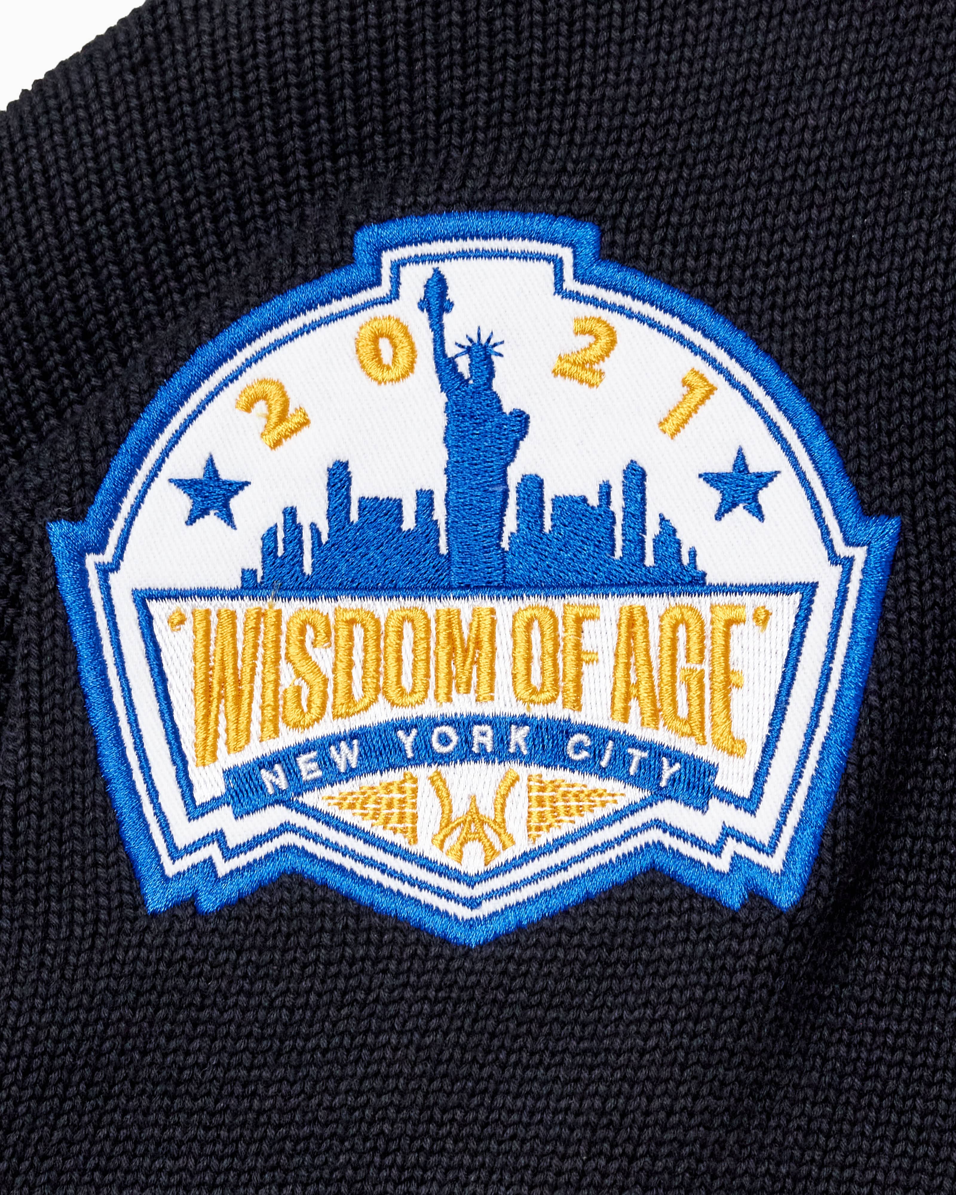 Patch with 'Wisdom of Age 2021 New York City' design on a black background