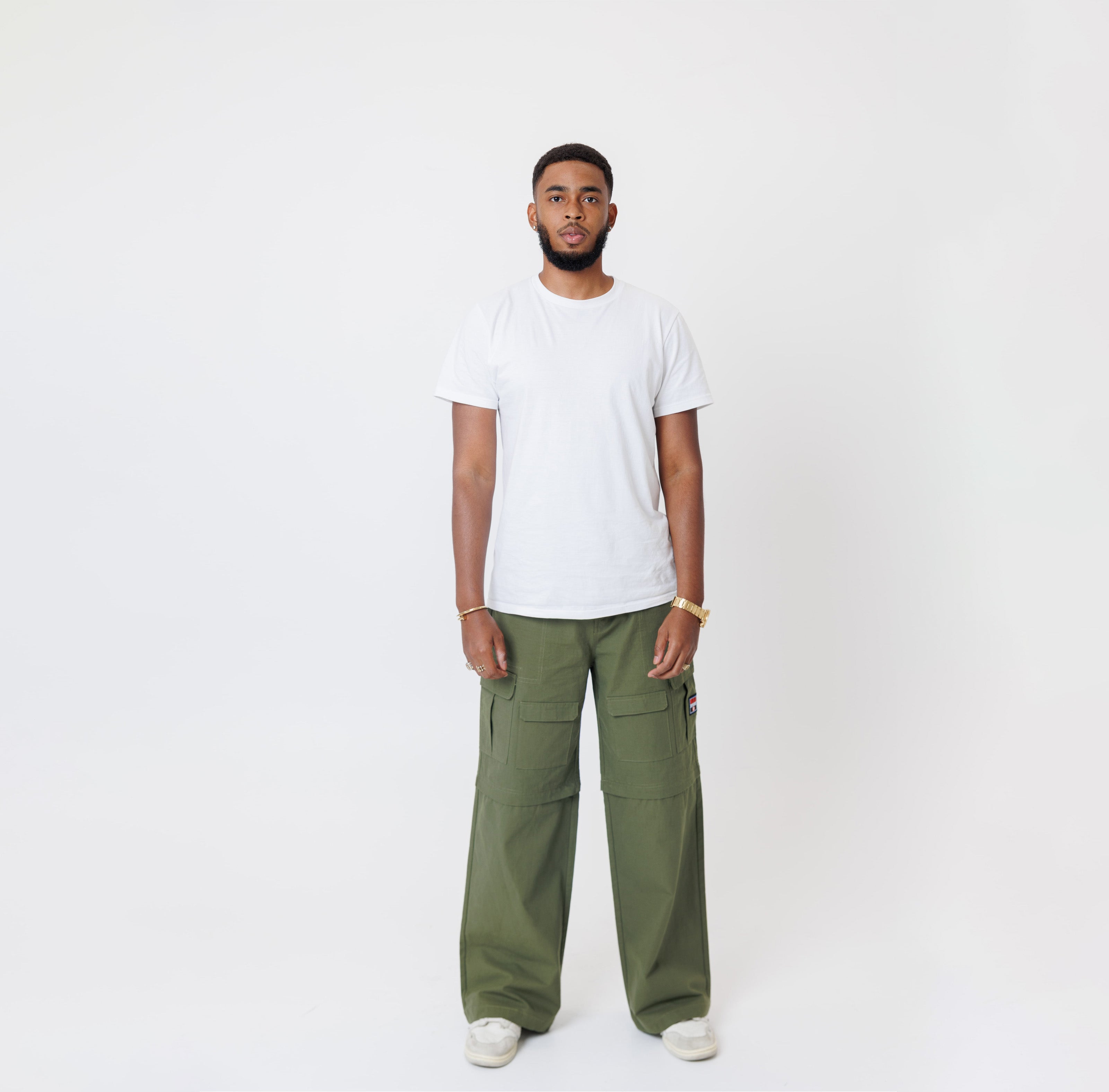 Male Model wearing a white t-shirt and the WOA Cargos in Olive color on a white background.