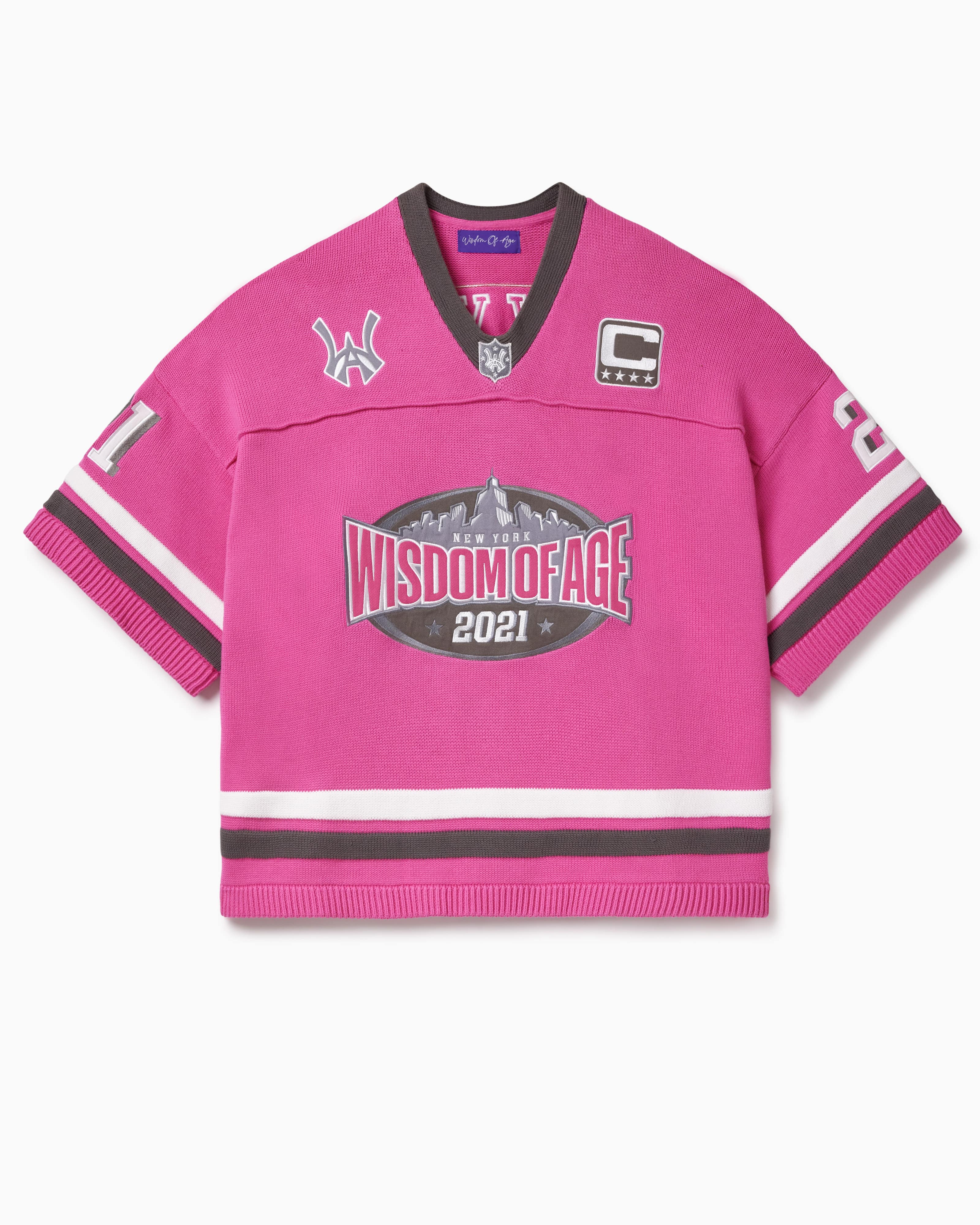 Pink knitted football jersey with Wisdom Of Age skyline, WA logos anda captains patch.