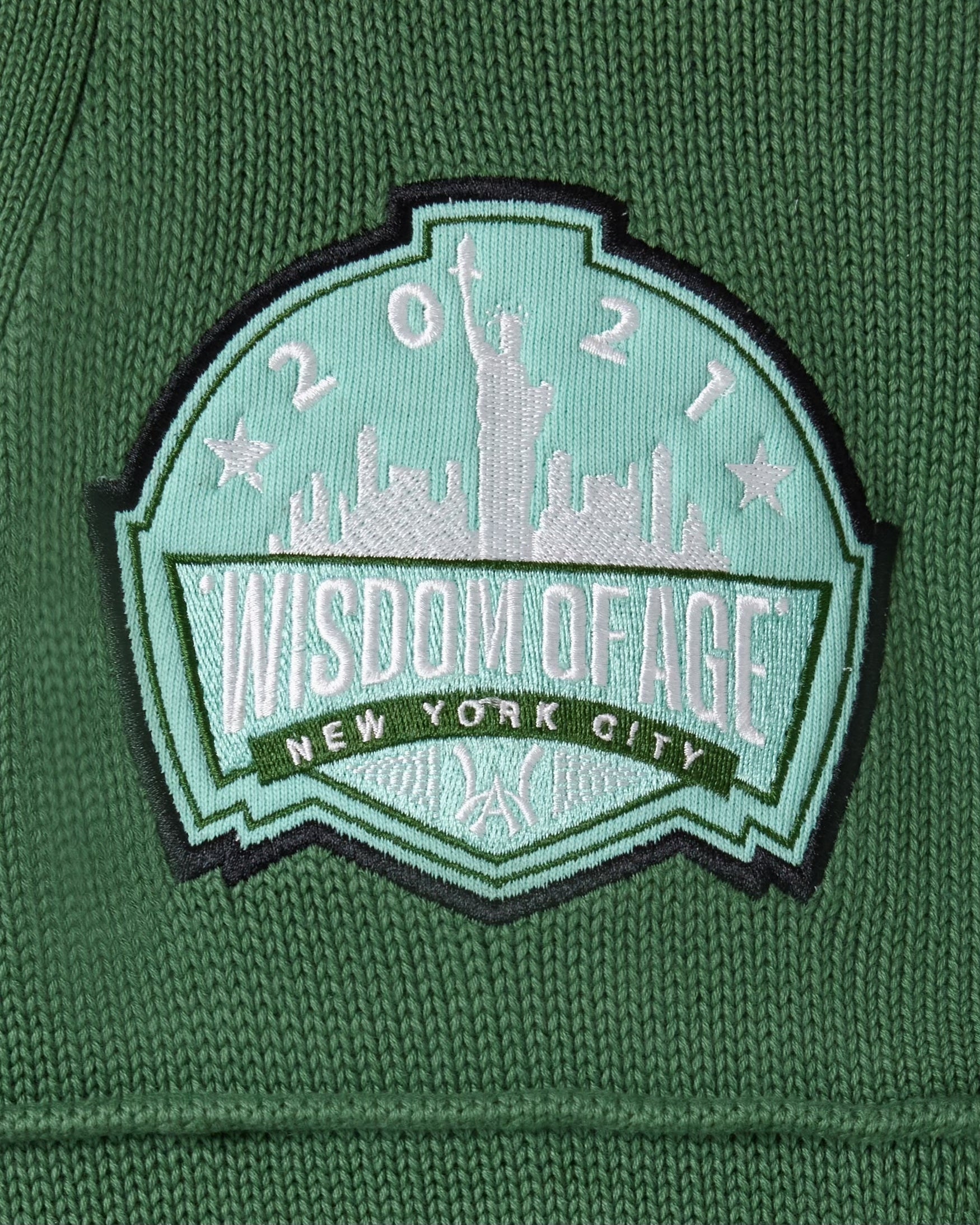 Wisdom Of Age Skyline patch with 'Wisdom of Age New York City' design on a sage green background