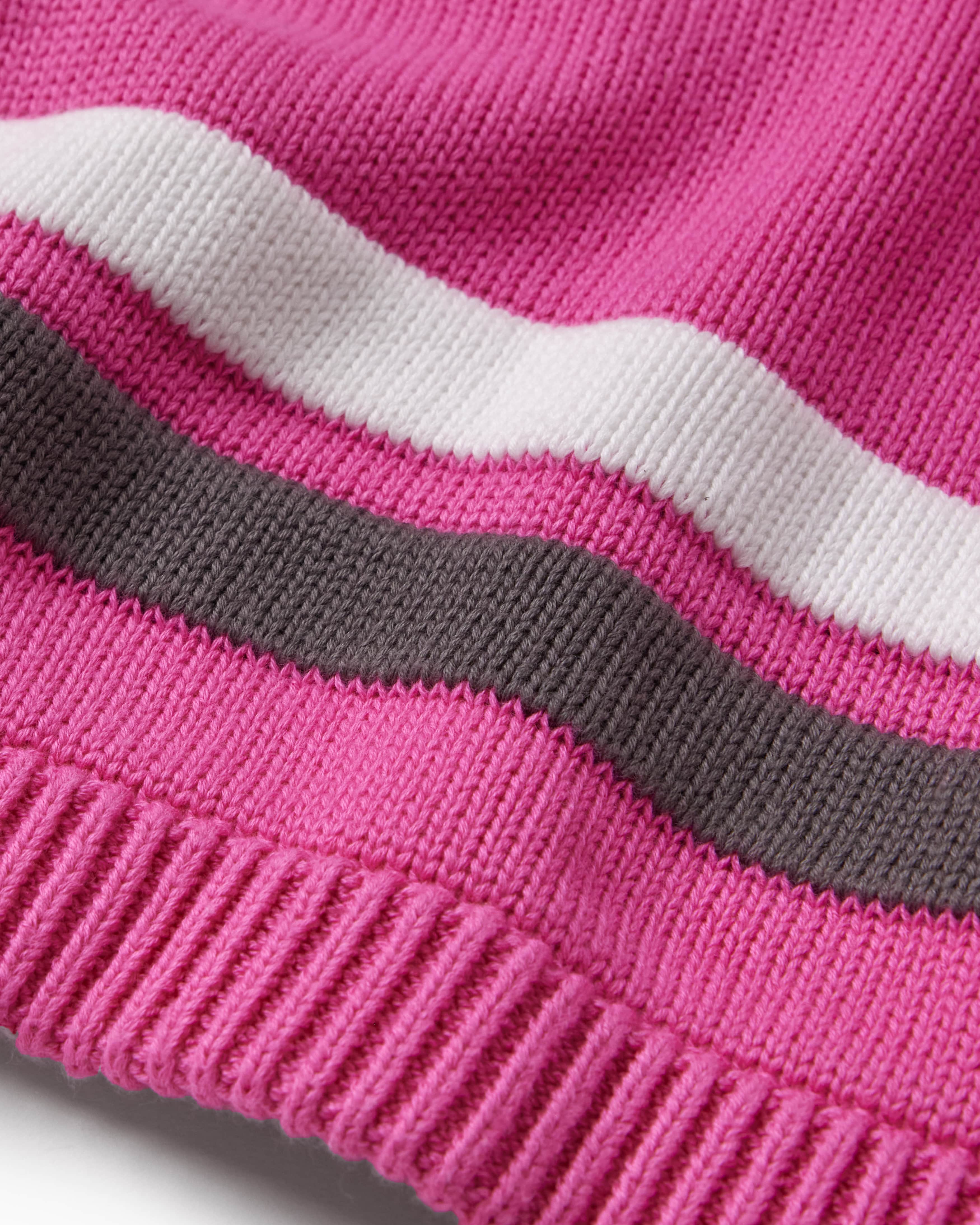 Close-up of a pink knitted football jersey with white and gray stripes on a white background