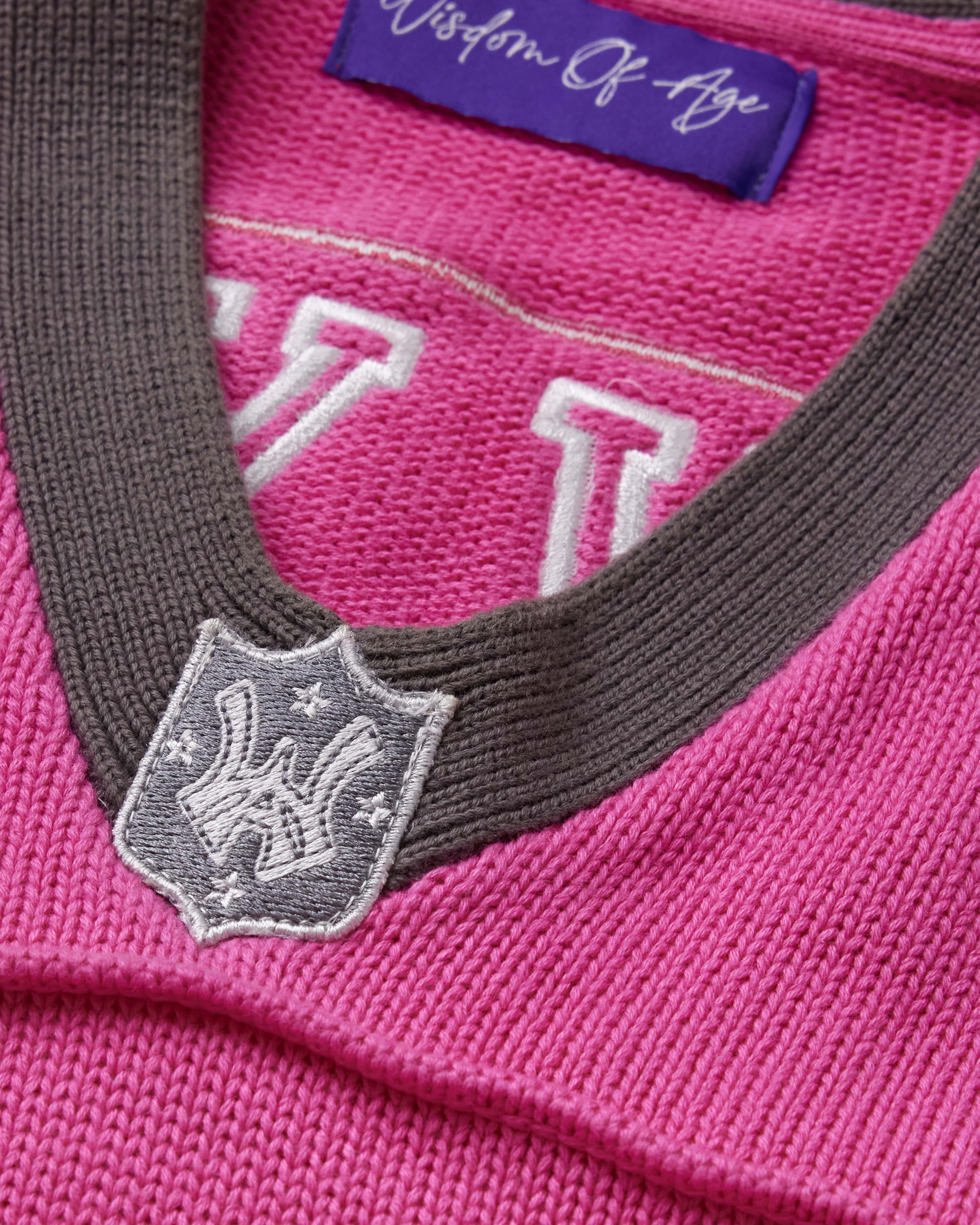 Close-up of the collar with an embroidered WA logo shield in charcoal.