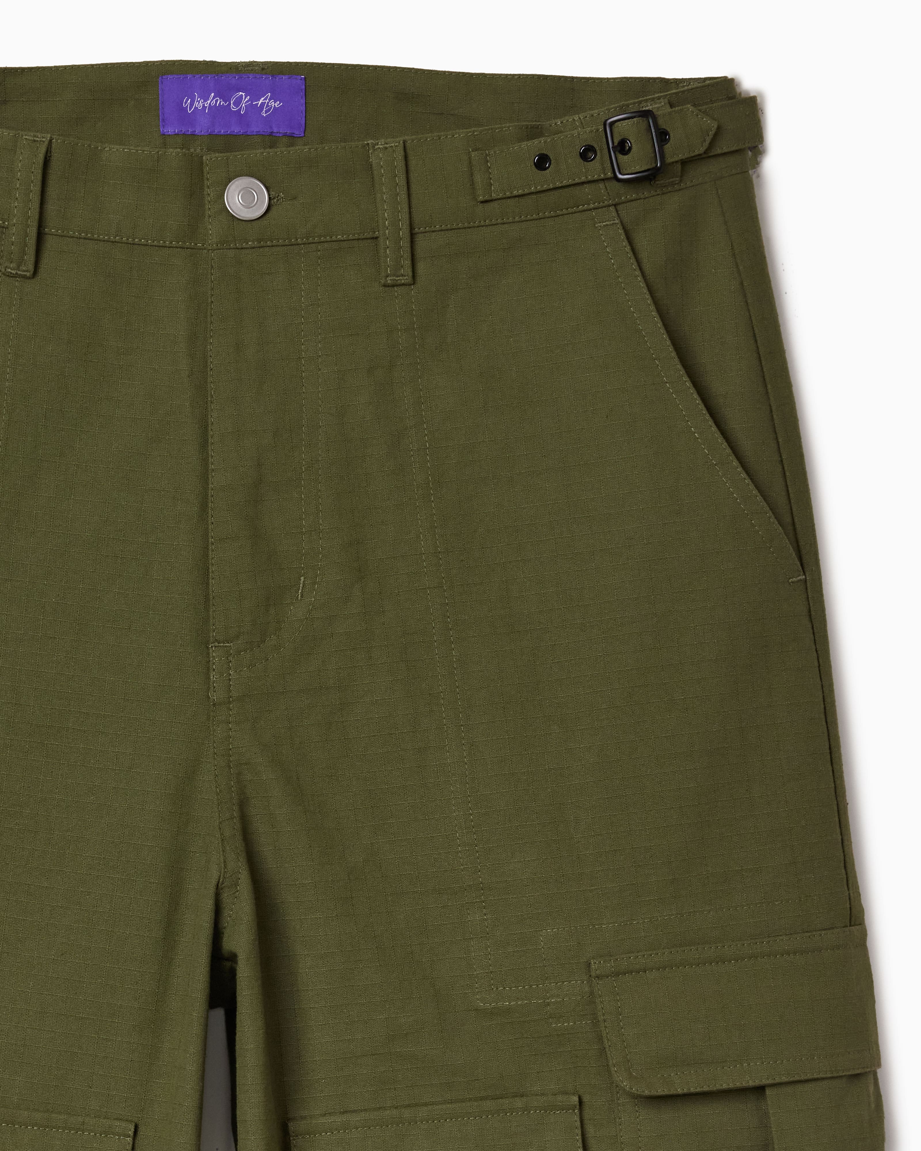 Green cargo pants with a belt and the Wisdom Of Age label on a white background