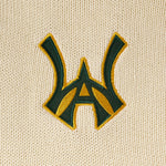 Embroidered WA logo on a Cream fabric background