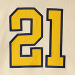 Yellow number '21' with blue border on cream background