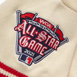 Patch on a cream knitted baseball jersey with 'WOA All-Star Game 2021' text