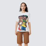 Female model wearing a white t-shirt with cartoon characters and brown shorts on a light gray background