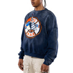 Side close view Male Model wearing a navy sweatshirt with a logo and beige cargo pants on a white background