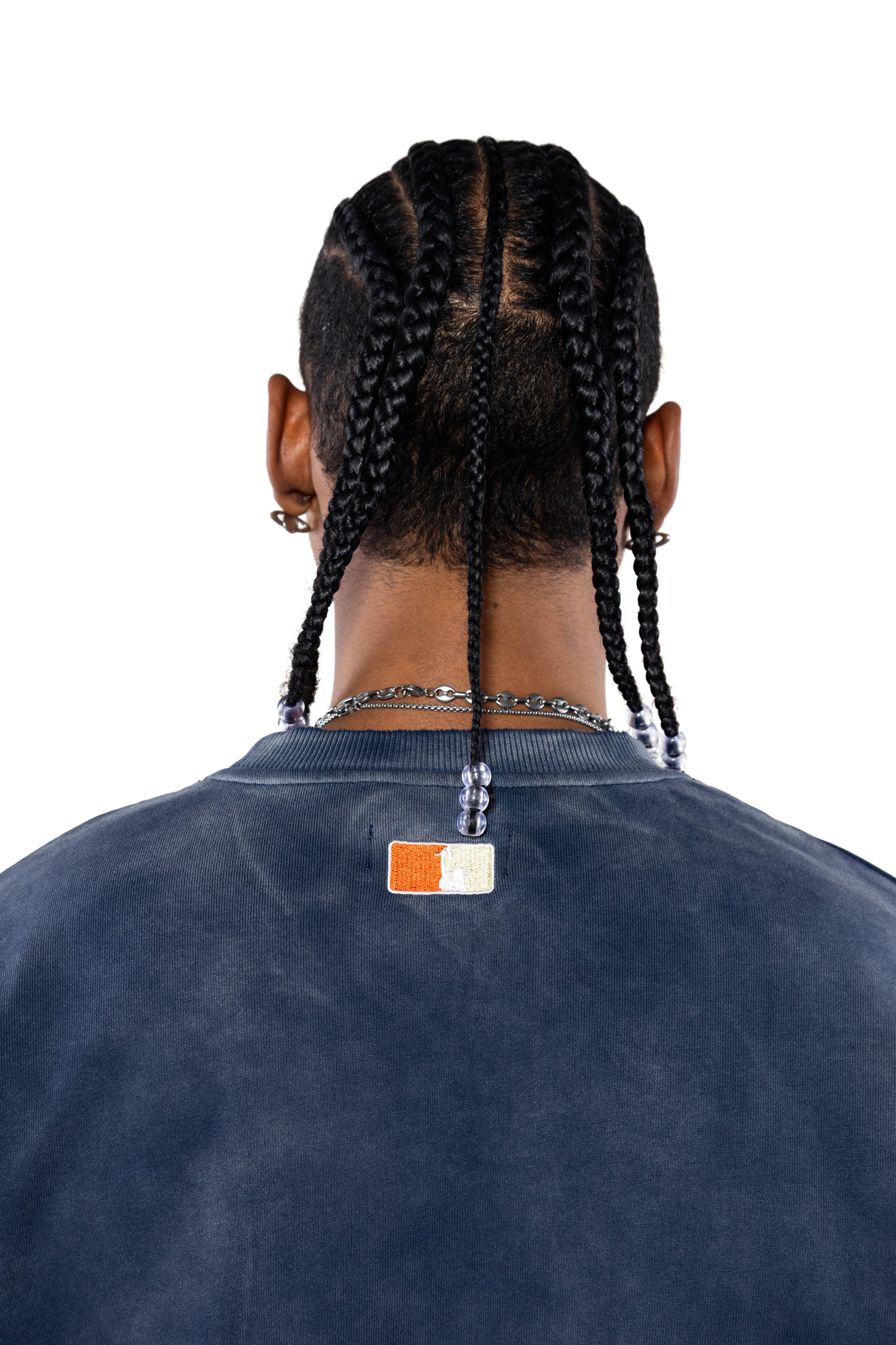 Rear view Male Model wearing a navy sweatshirt with the 'NY Tough' logo on the neck.