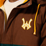 Close up of Brown jacket with yellow hood and embroidered 'WA' logo with a yellow outline on a white background