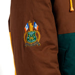 Brown jacket with a embroidered  WOA Liberty patch on the sleeve against a white background.