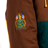 Brown jacket with a embroidered  WOA Liberty patch on the sleeve against a white background.