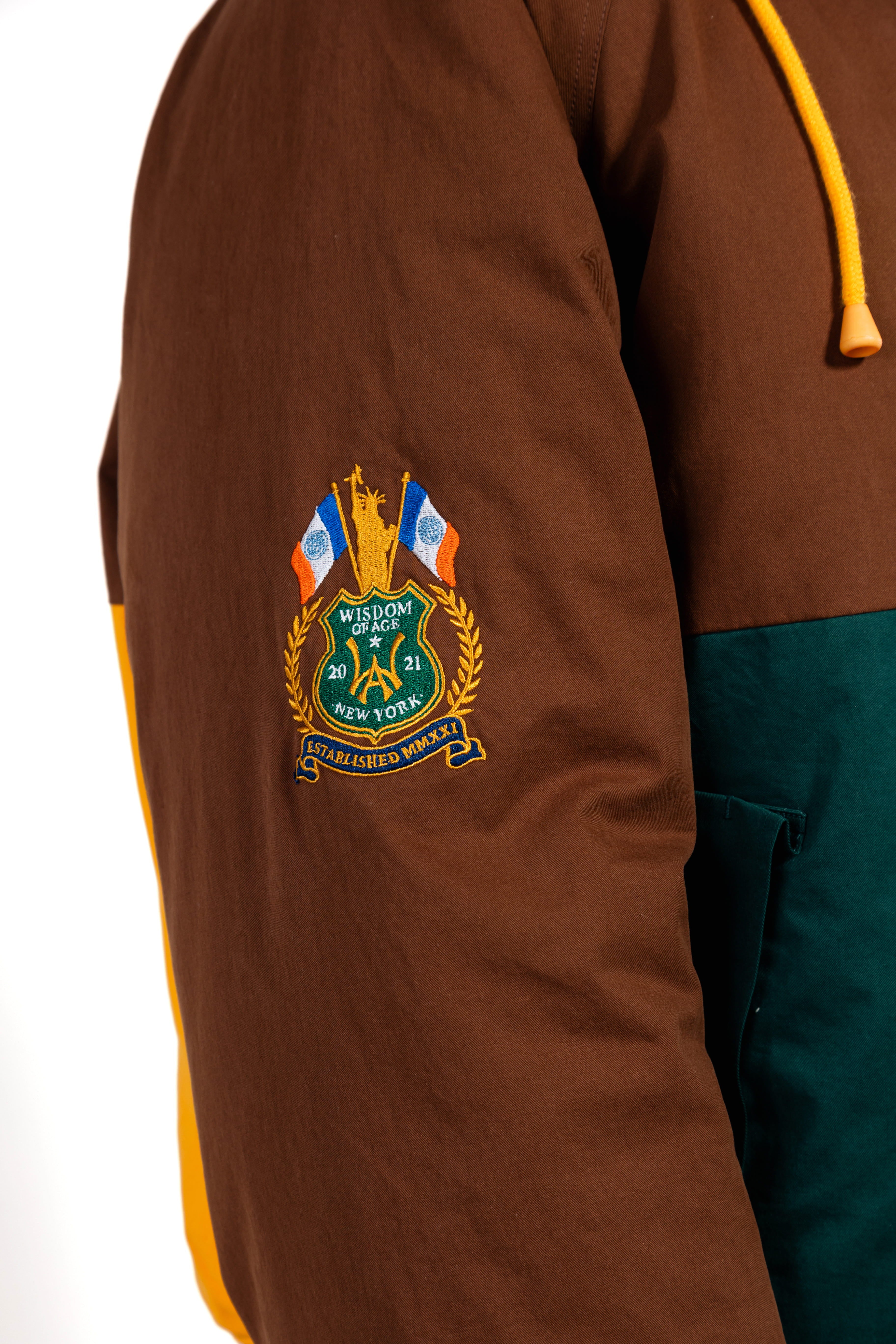 Brown jacket with a embroidered  WOA Liberty patch on the sleeve against a white background.