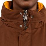 Close-up of a brown jacket with a 'WA' logo zipper.