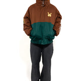 Male Model wearing a brown and green jacket with a embroidered 'WA' logo on a white background