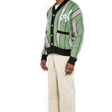 Side view of Male model wearing the WOA City cardigan mint on a white background.