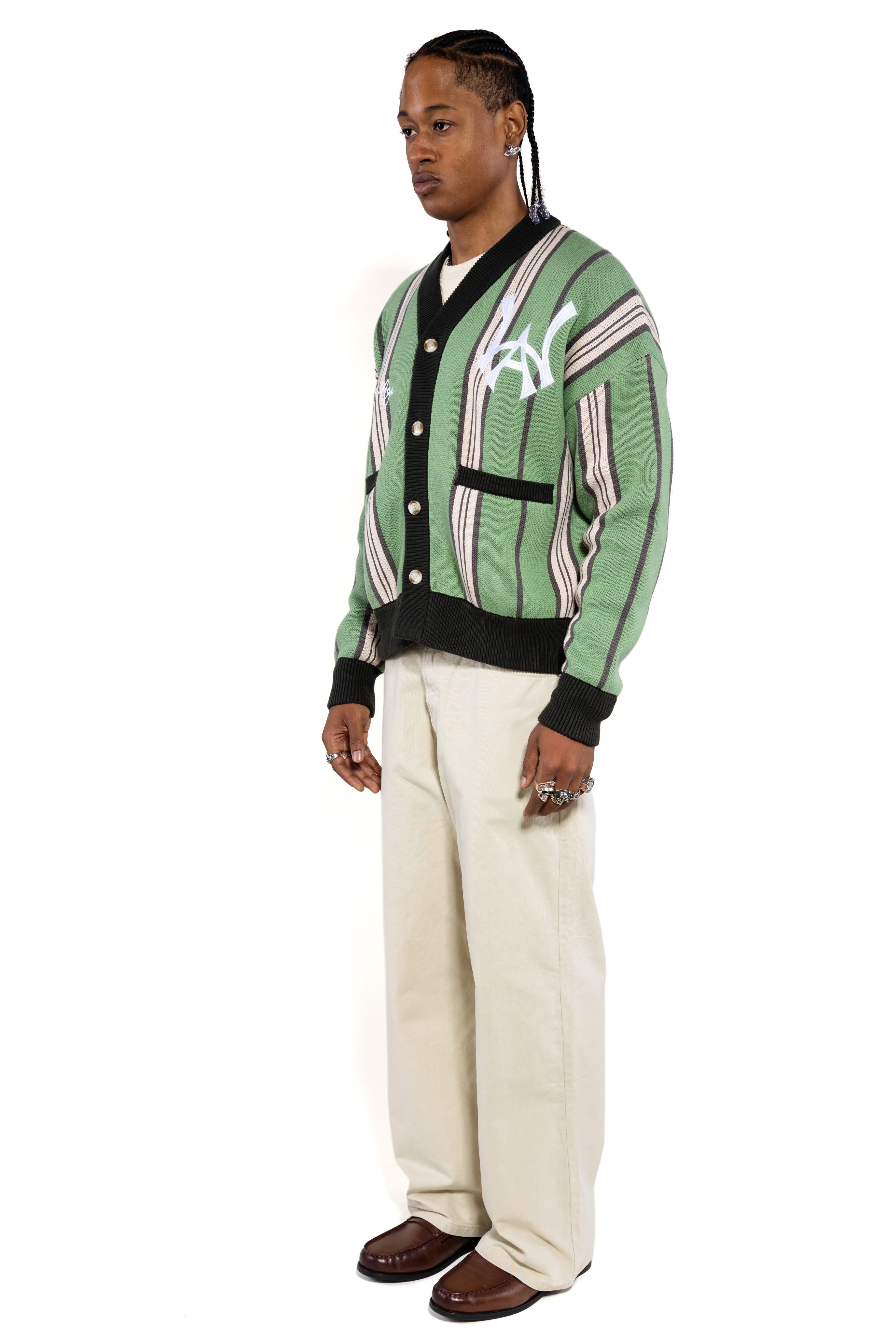 Side view of Male model wearing the WOA City cardigan mint on a white background.