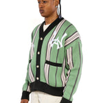 Close, sideview of a Male model wearing the WOA City cardigan mint on a white background. 'WA Logo' embroidered on the left chest.