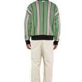 Rear full body view of a Male model wearing the WOA City cardigan mint on a white background.