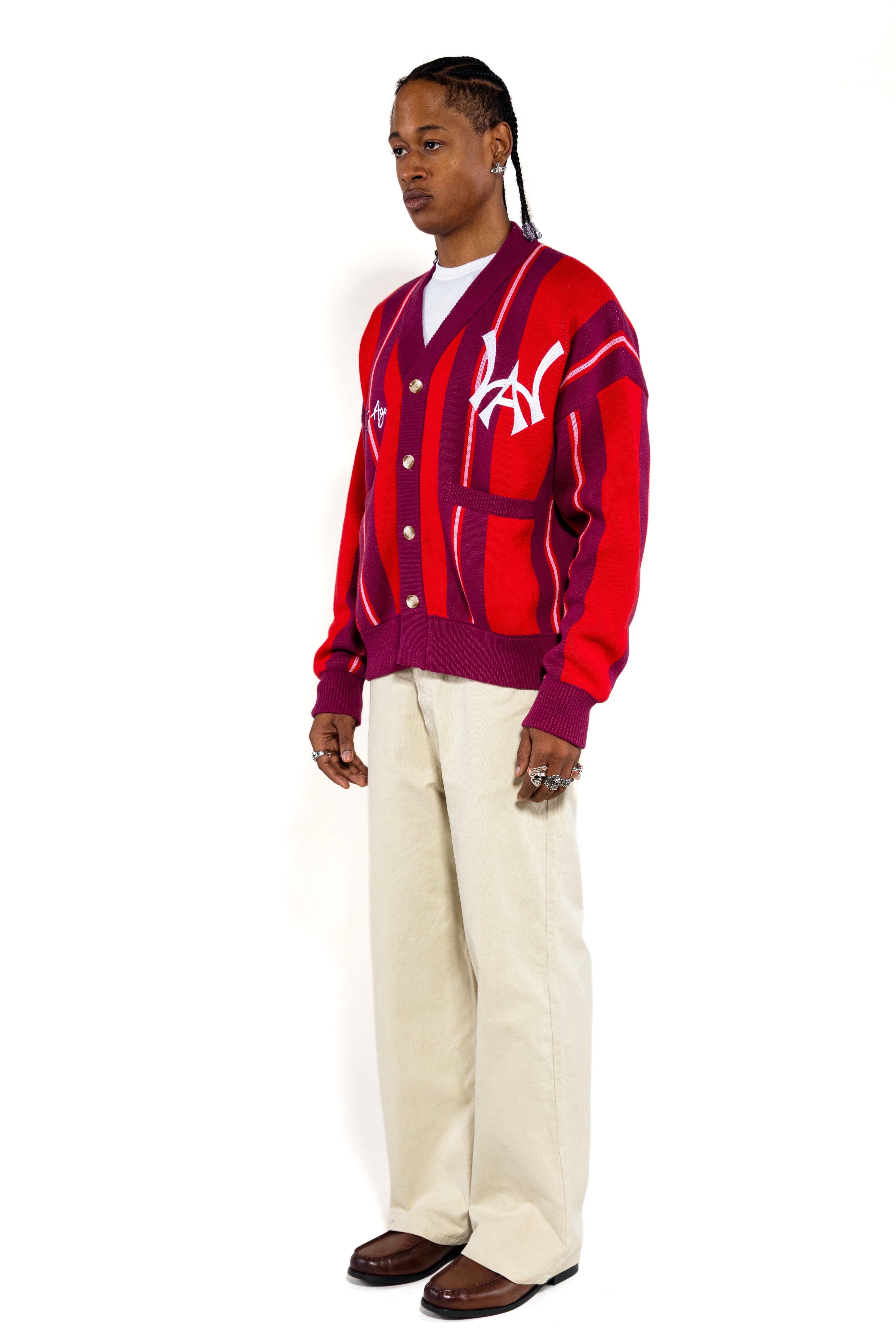 Full body side view of a Male Model Wearing the Wisdom Of Age City Cardigan in Red Velvet on a white background.
