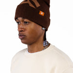 Male Model wearing a brown beanie with the 'WA' logo and the WOA Cream thermal on a white background.
