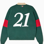 Green rugby sweater with number 21 on the back against a white background