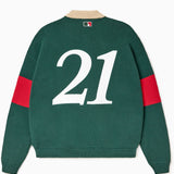 Green rugby sweater with number 21 on the back against a white background