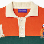 Close up of the Orange and green rugby sweater with a Wisdom Of Age label on a white background