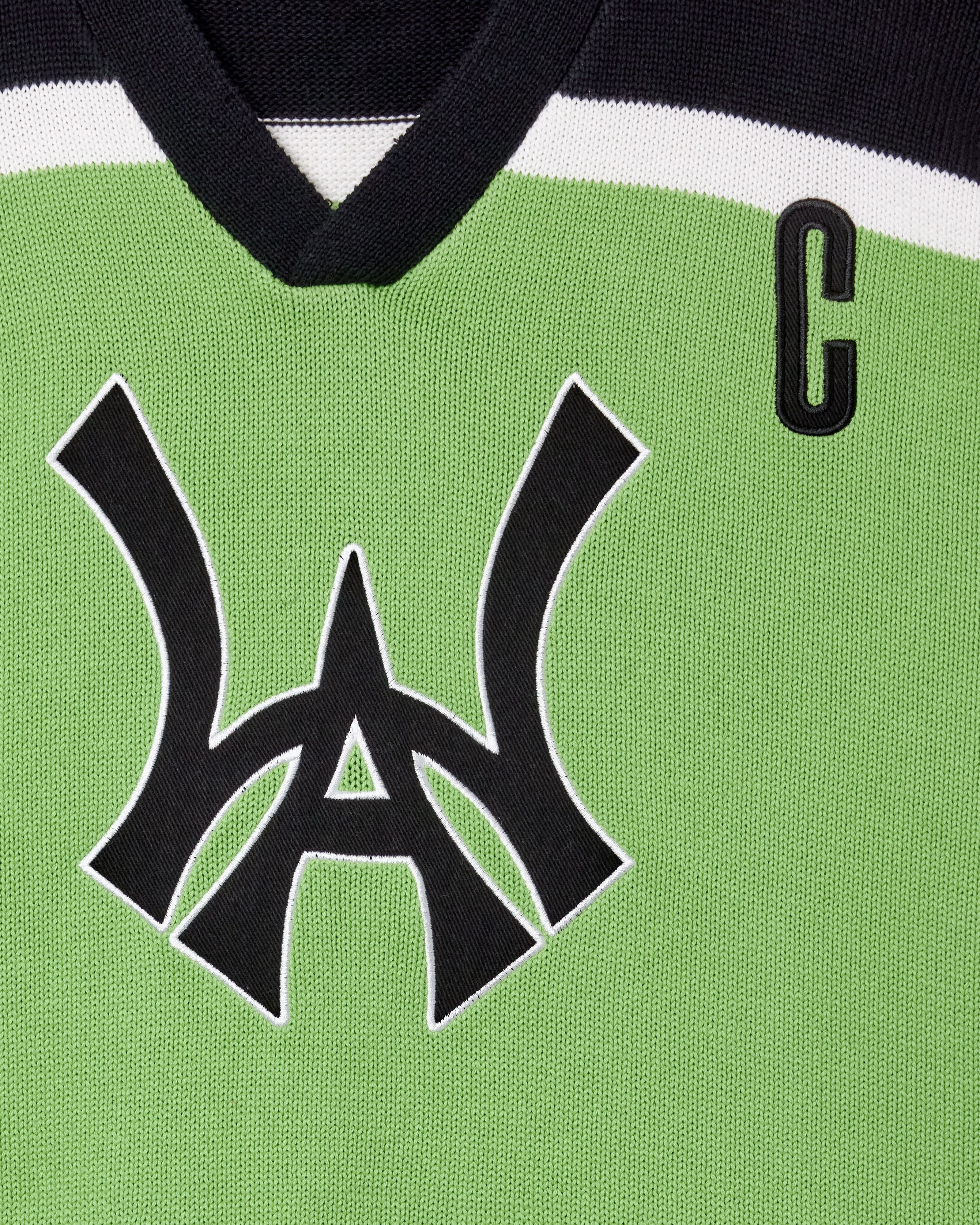 Close Up Of The Wisdom Of Age Knit Hockey Jersey Neon Front View