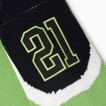 Close-up of a green and black Sleeve with the number 21 on a white background
