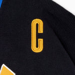 Black sports jersey with a yellow 'C' emblem on a white background