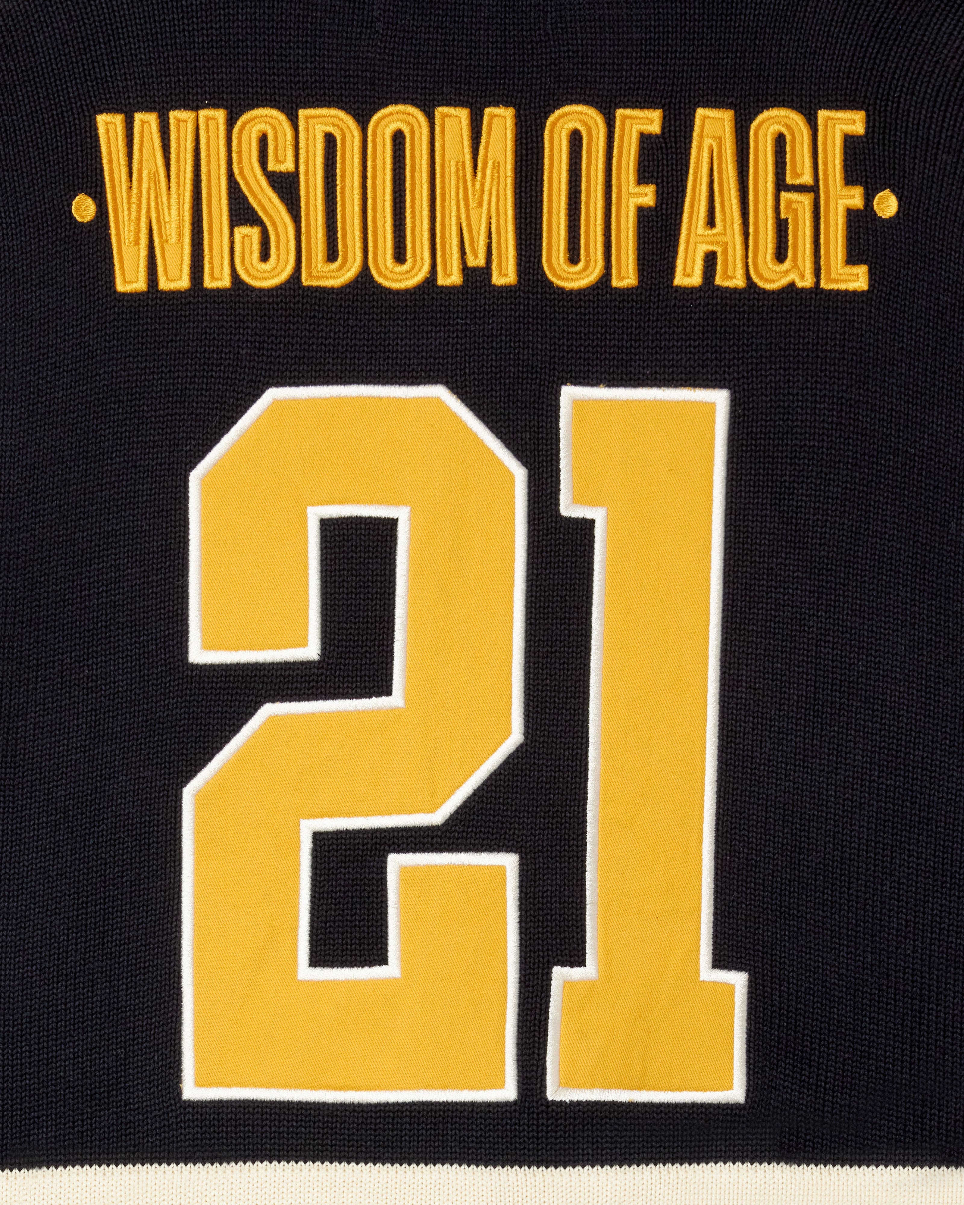Black Jersey with 'Wisdom of Age' and number '21' in gold on a black background
