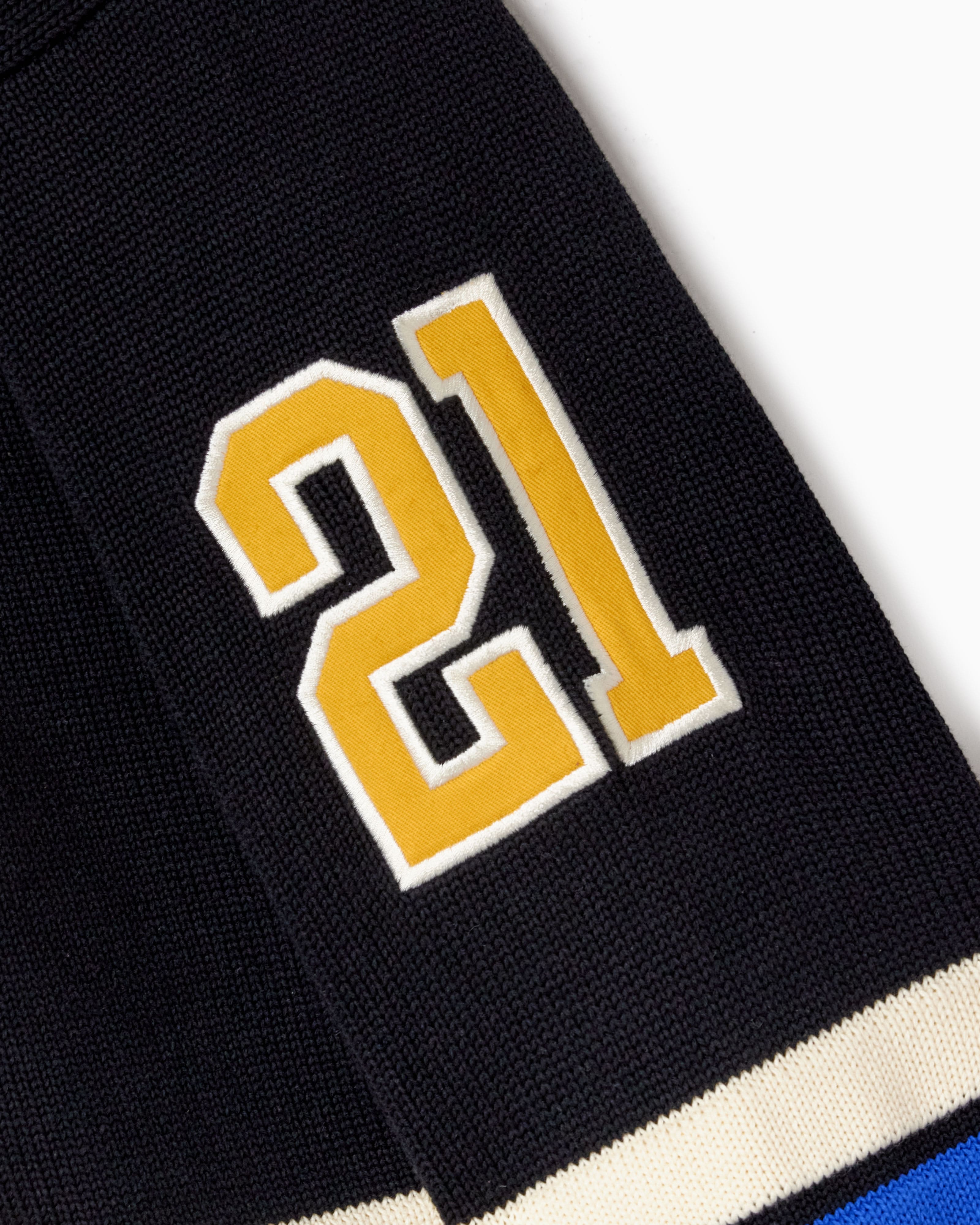 Black sweater with yellow number 21 on a white background