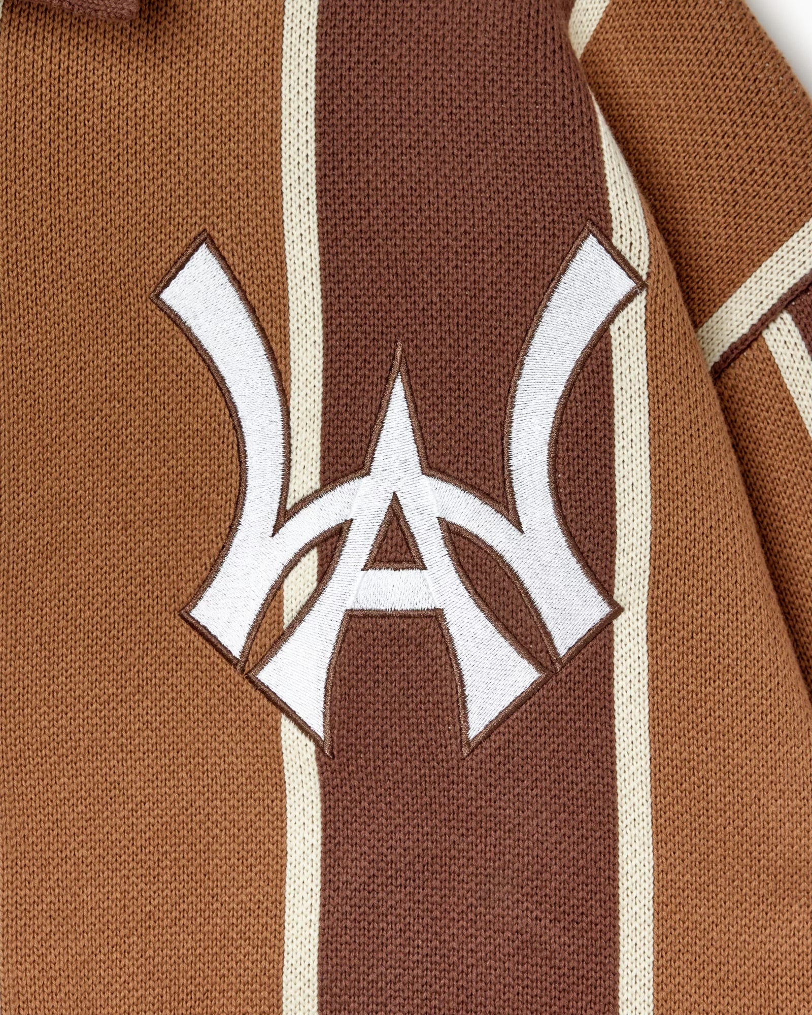 Close up of the WOA Knitted Brown and beige striped cardigan with WA logo on the left chest on a white background.