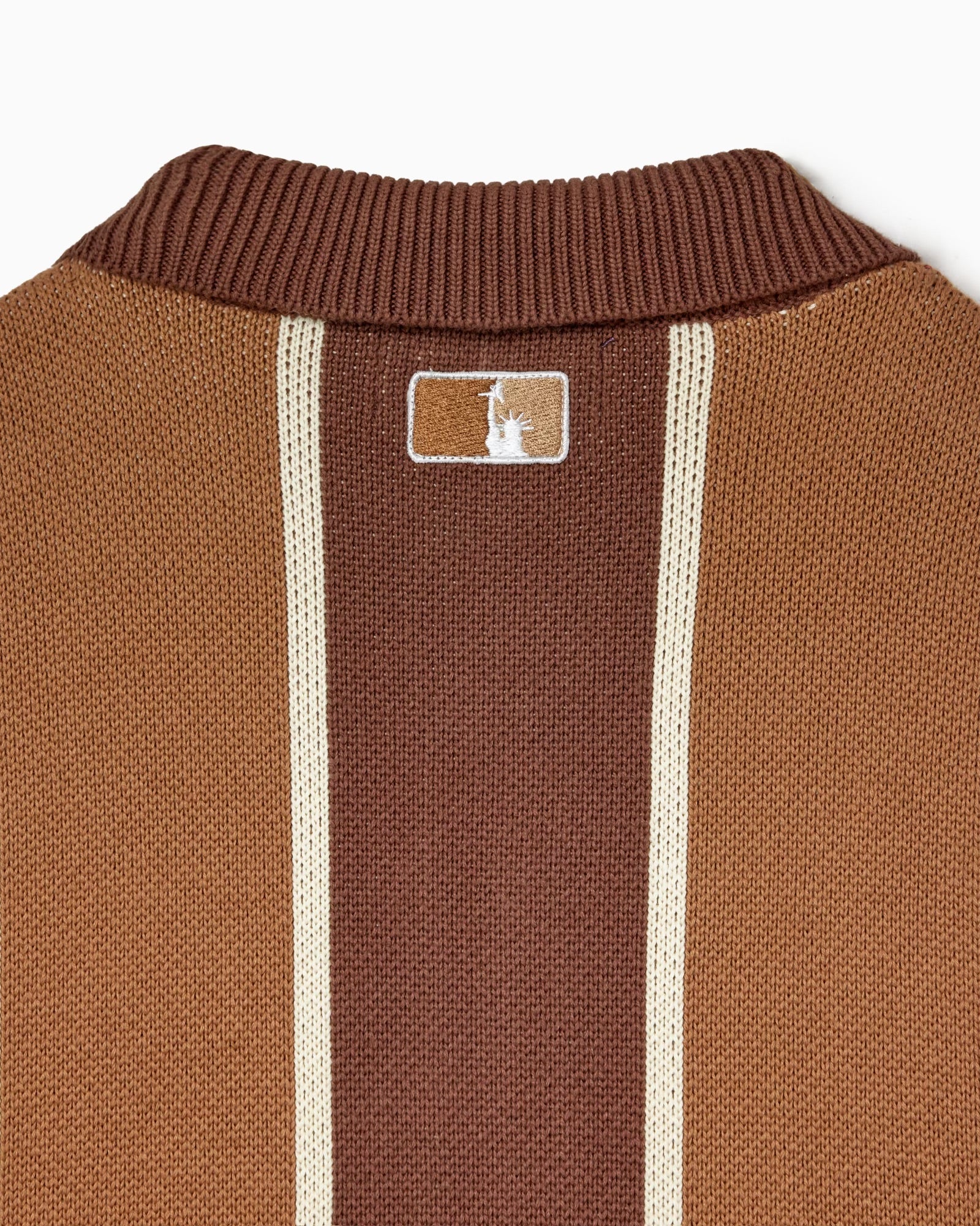 Knitted Brown cardigan with the WOA liberty logo on a white background.