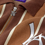 Close-up of the brown and beige patterned cardigan with a WA logo zipper and visible 'Wisdom Of Age' label.