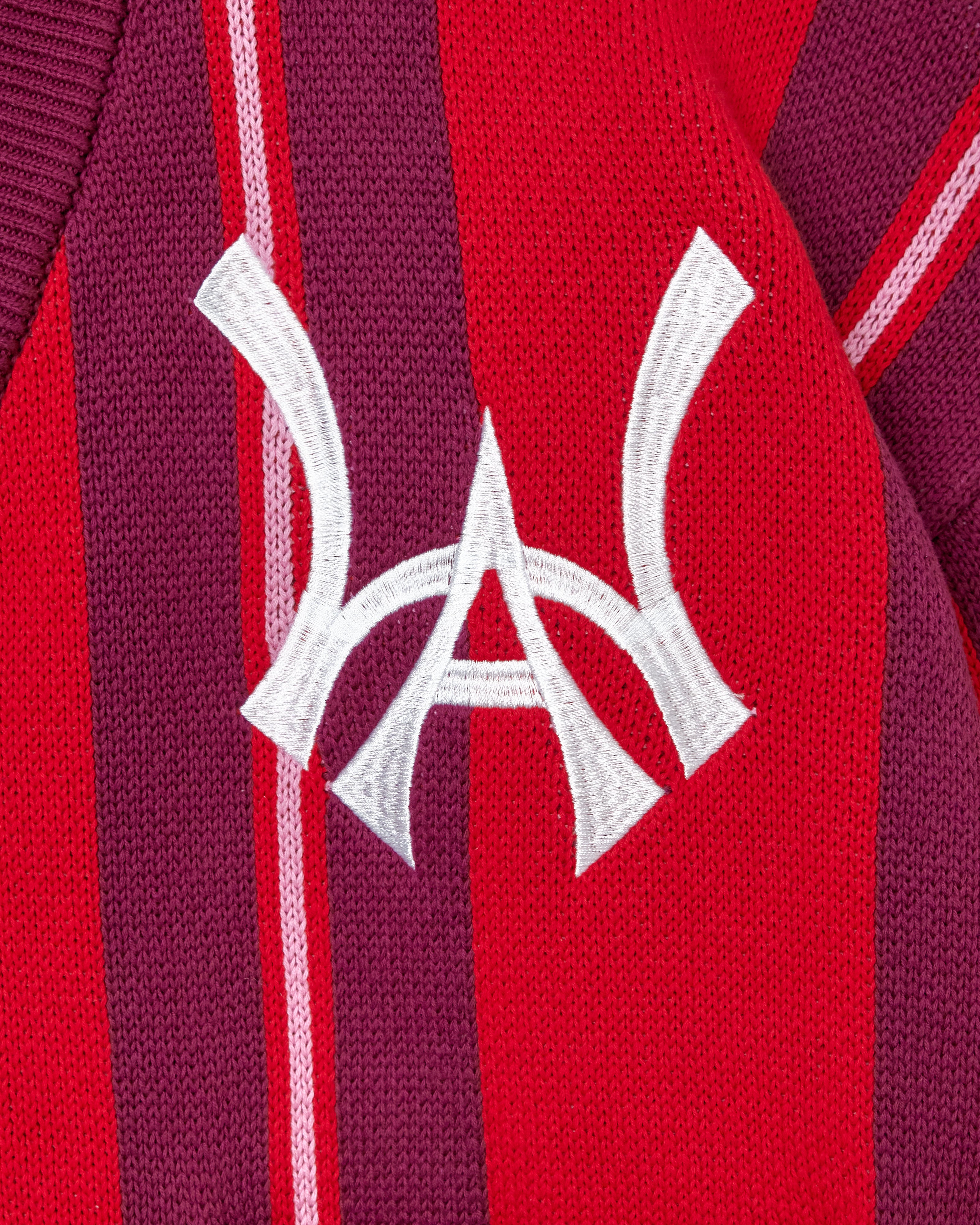 Close-up of a red and maroon Cardigan with the WA logo.