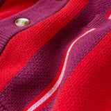 Close-up of a red and purple cardigan with button details