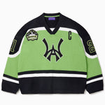 Front view of the Wisdom Of Age Knit Hockey jersey Neon. WA logo on the front with and captains C on the left shoulder and a nyc skyline patch on the right shoulder. the number 21 on the sleeves