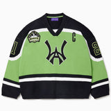 Front view of the Wisdom Of Age Knit Hockey jersey Neon. WA logo on the front with and captains C on the left shoulder and a nyc skyline patch on the right shoulder. the number 21 on the sleeves