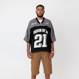 Male Model wearing a the WOA Football jersey V2 Slate with 'Wisdom Of Age' and number '21' embroidered on the front on a white background