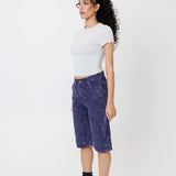 Side view of a Female model wearing a white t-shirt and Wisdom of age canvas carpenter shorts in purple color on a light gray background