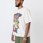 male model wearing a white t-shirt with cartoon characters and olive cargo pants on a light gray background