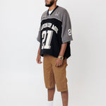 Side view Male Model wearing the WOA Football jersey V2 Slate with number 21 on a white background