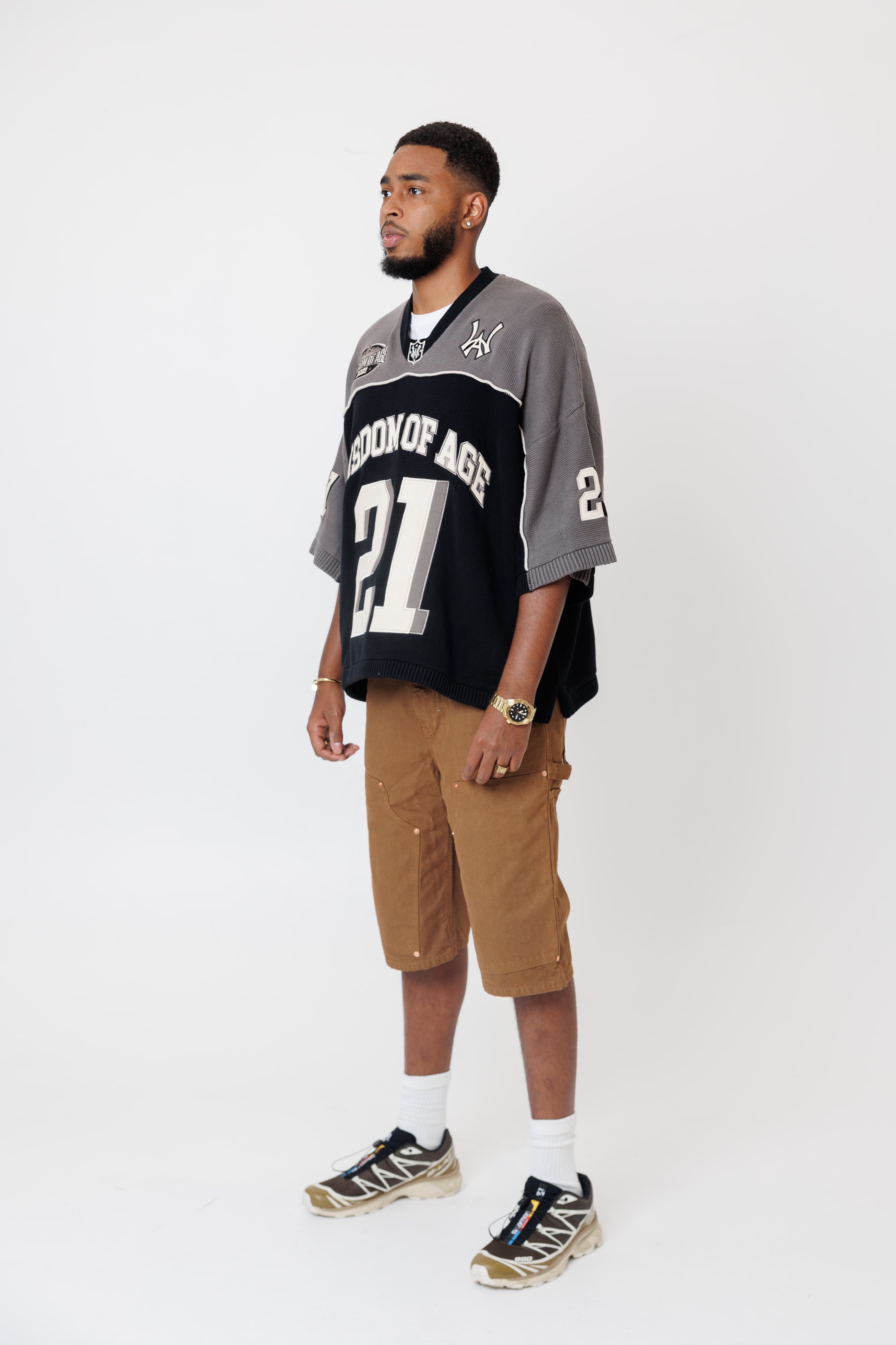 Side view Male Model wearing the WOA Football jersey V2 Slate with number 21 on a white background
