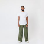 Male Model wearing a white t-shirt and the WOA Cargos in Olive color on a white background.