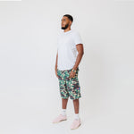 Side view Male Model wearing a white t-shirt and the WOA convertible Cargos in Camo color on a white background.