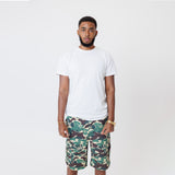 Male Model wearing a white t-shirt and the WOA convertible Cargo shorts in Camo color on a white background.