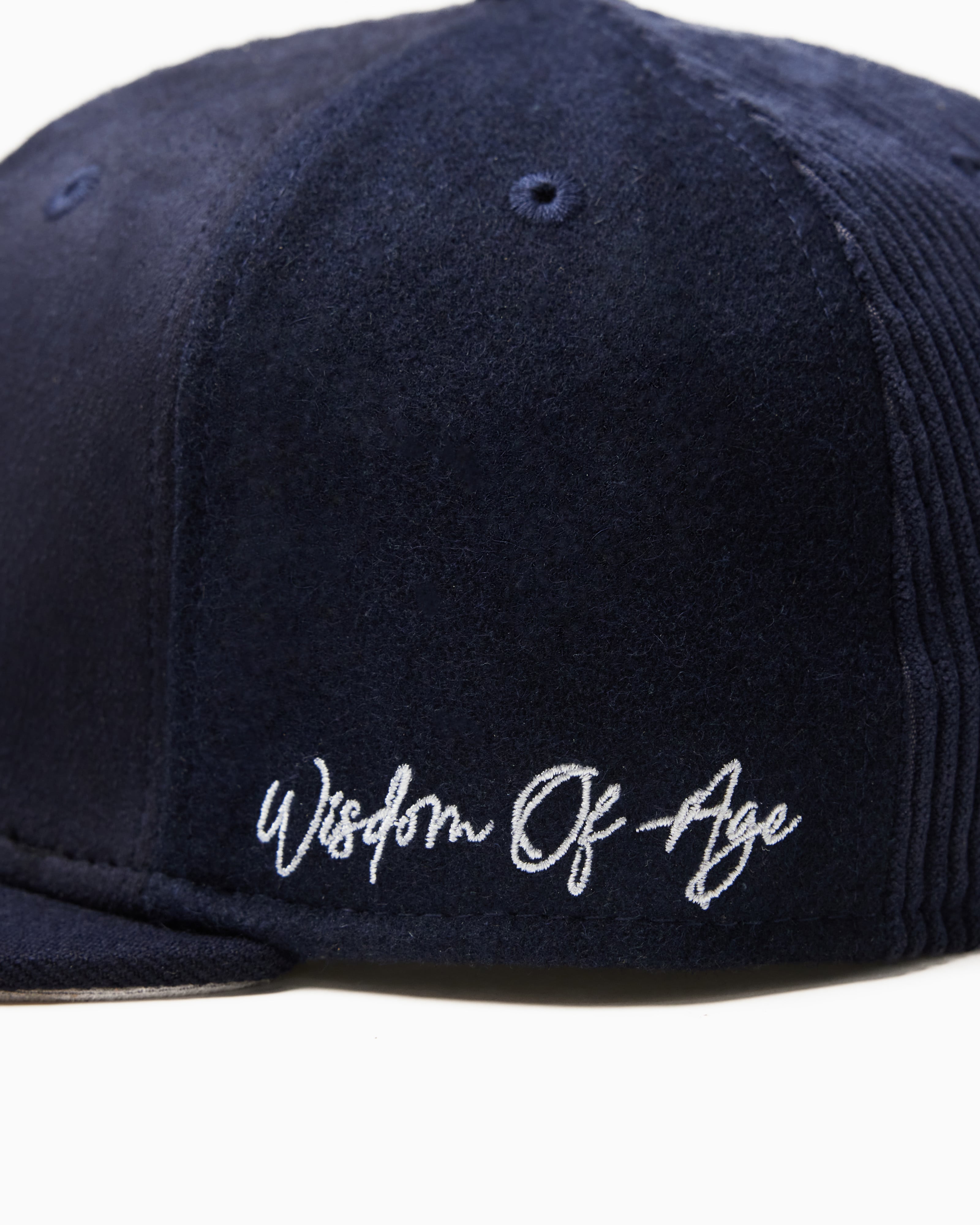 Wisdom Of age Logo Fitted Hat Navy side view Close up