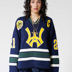 Front View Of A Female Model wearing The Navy, Yellow and Green Wisdom Of Age Knit Hockey Jersey.